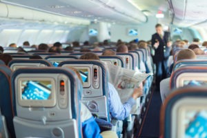 50082148_l interior of airplane with passengers on seats during flight.