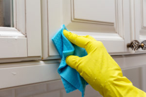 How do you clean sticky wood cabinets